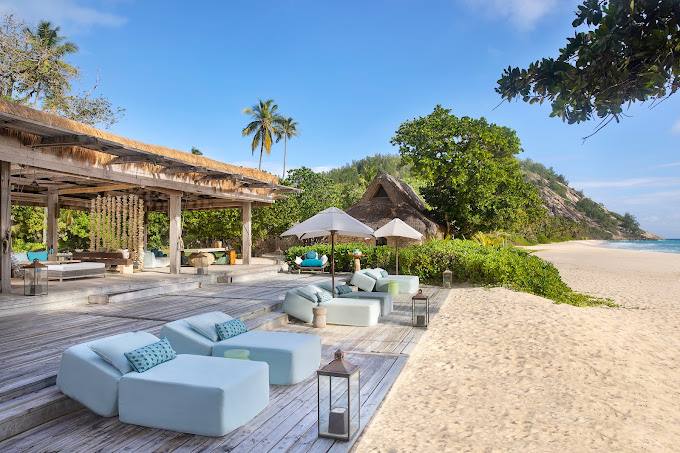 Villa von North Island zwischen Granitfelsen und tropischer Vegetation über dem Strand auf den Seychellen